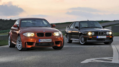 BMW Série 1 M - orange - à côté d'une M3 MkII