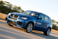 BMW X5 M bleu 3/4 avant gauche travelling penché