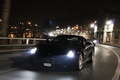Ferrari 599 GTB Fiorano noir voies sur berges 3/4 avant gauche travelling