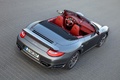 Porsche 911 Turbo cabrio 2009 - grise - 3/4 supérieur arrière droit et habitacle