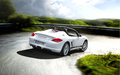 Porsche Boxster Spyder blanc 3/4 arrière droit travelling