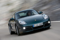 Porsche Cayman S vert 3/4 avant droit travelling penché