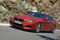 BMW M6 orange 3/4 avant gauche travelling penché