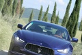 Maserati Ghibli bleu face avant travelling penché debout