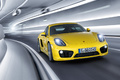 Porsche Cayman S jaune 3/4 avant droit travelling penché