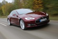 Tesla Model S bordeaux 3/4 avant droit travelling penché