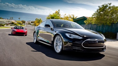 Tesla Model S noir 3/4 avant droit & Roadster Sport rouge face avant travelling penché