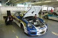 Porsche 997 GT3 RSR blanc/bleu 3/4 avant droit stands
